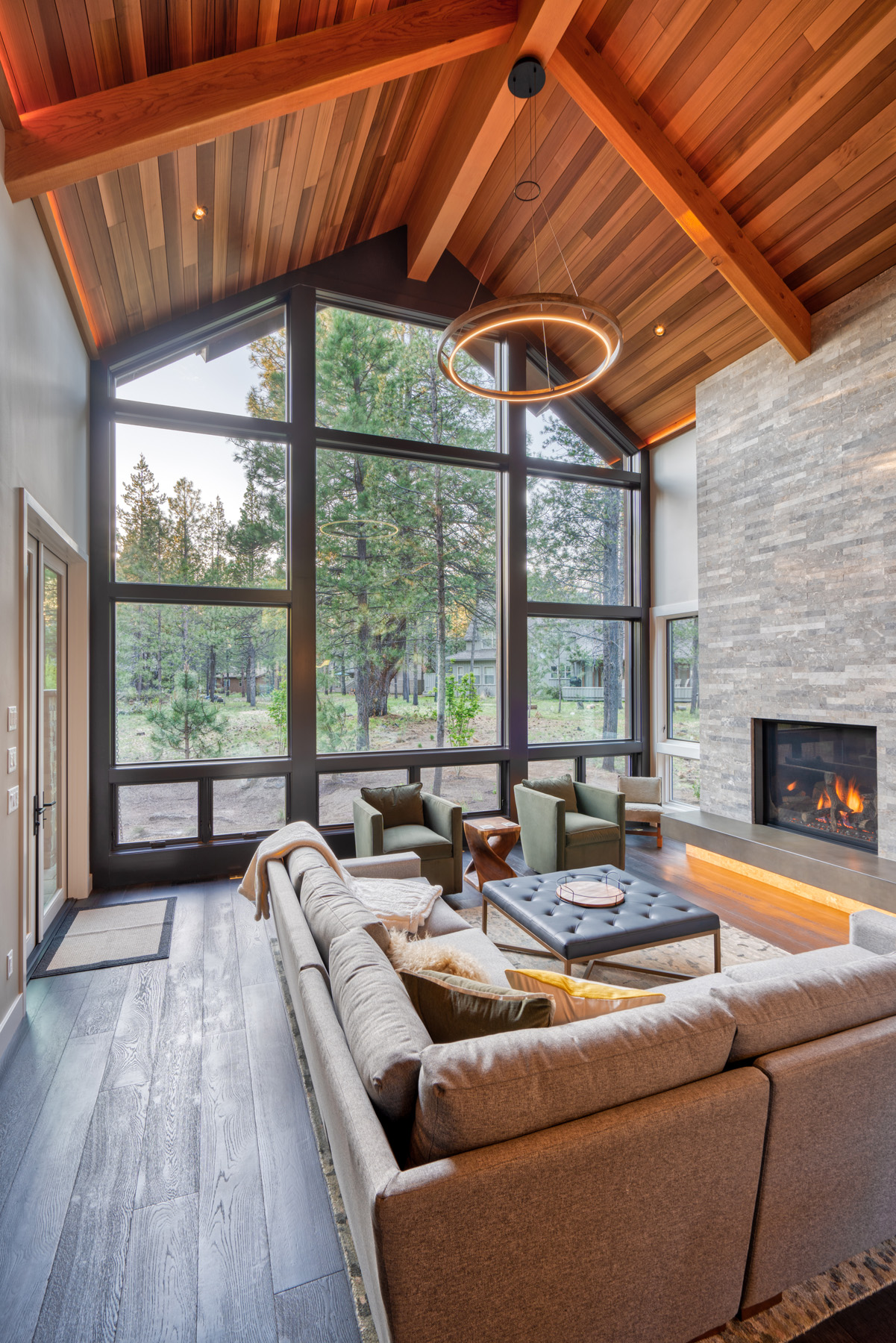 Great room's 21' window wall and stone fireplace